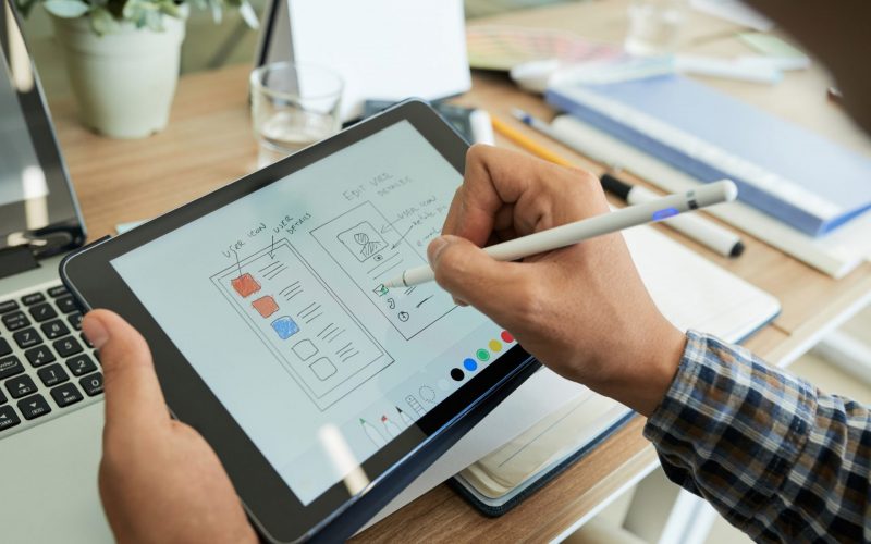 ui-designer-drawing-sketch-of-mobile-app-e1658932486393-psdwj12wfkb4pawey5ho4l33q85qm05zglcfivqw08
